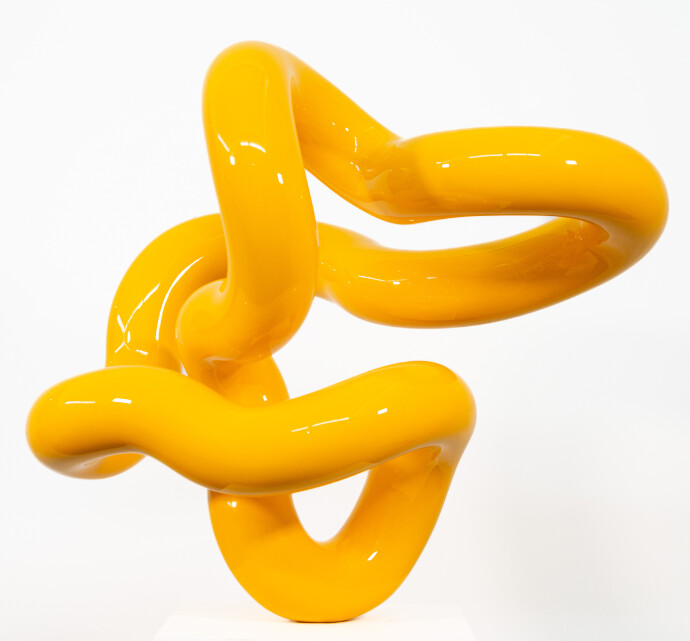 This minimalist metal outdoor sculpture in bright yellow was created by Canadian sculptor Alexander Caldwell.