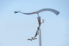 The graceful flight of two birds is captured in this stunningly elegant contemporary sculpture by Amos Robinson. Image 5