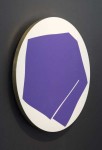 In this dynamic work by Aron Hill, a deep violet geometric shape sits against a white tondo (circle) framed by a black canvas. Image 2