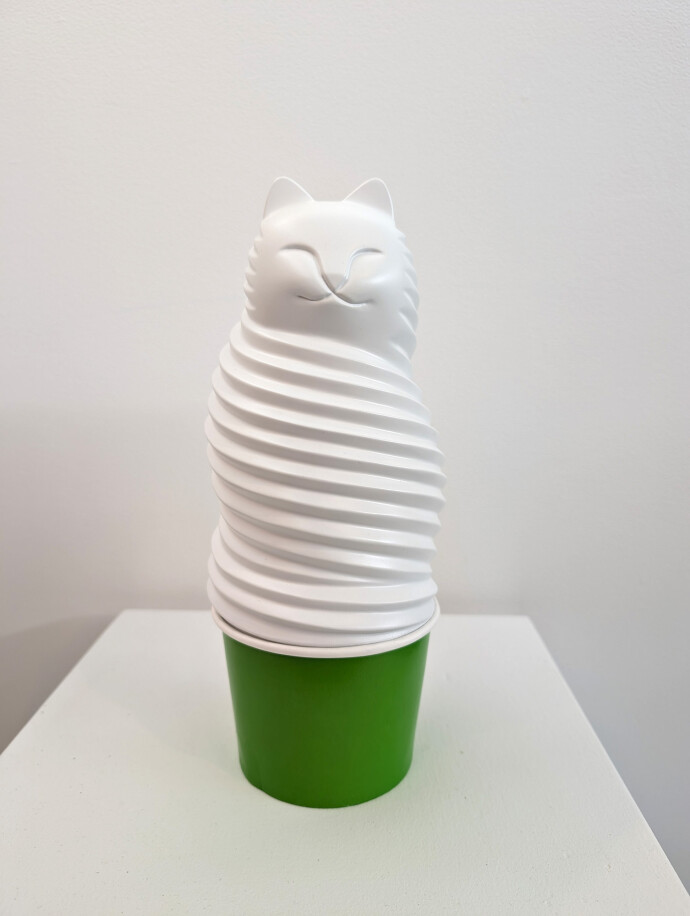 This pop art table top sculpture is a playful colorful figure of a cat.