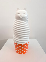 This pop art table top sculpture is a playful colorful figure of a cat.