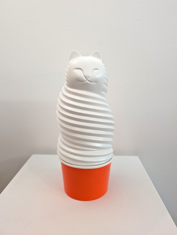 This pop art table top sculpture is a playful colorful figure of a cat.