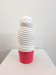 This pop art table top sculpture is a playful colorful figure of a cat.