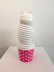 This pop art table top sculpture is a playful colorful figure of a cat.