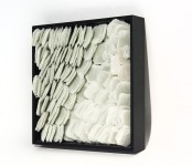 Layered petals of white glass frit are composed within a black lacquer frame by artist Cheryl Wilson Smith. Image 2