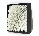 Layered petals of white glass frit are composed within a black lacquer frame by artist Cheryl Wilson-Smith. Image 2