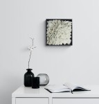 Layered petals of white glass frit are composed within a black lacquer frame by artist Cheryl Wilson-Smith. Image 6