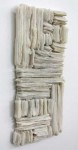 Wafers of cool white glass frit are layered and stacked in a curated wall relief by Cheryl Wilson Smith. Image 2