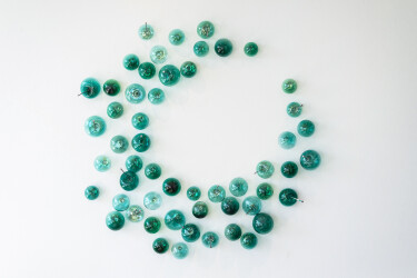 This contemporary turquoise-colored glass wall sculpture was created by a Canadian artist.