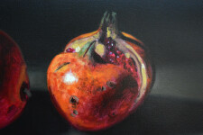 Two red-orange pomegranates, one cut cleanly in half are set on a dark ground in this realistically rendered and intimate oil painting on ca… Image 2