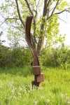 An elegantly curved column of corten steel appears to almost float in mid-air in this arresting outdoor sculpture by Claude Millette. Image 5