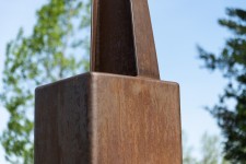 An elegantly curved column of corten steel appears to almost float in mid-air in this arresting outdoor sculpture by Claude Millette. Image 2