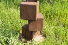 An elegantly curved column of corten steel appears to almost float in mid-air in this arresting outdoor sculpture by Claude Millette. Image 6