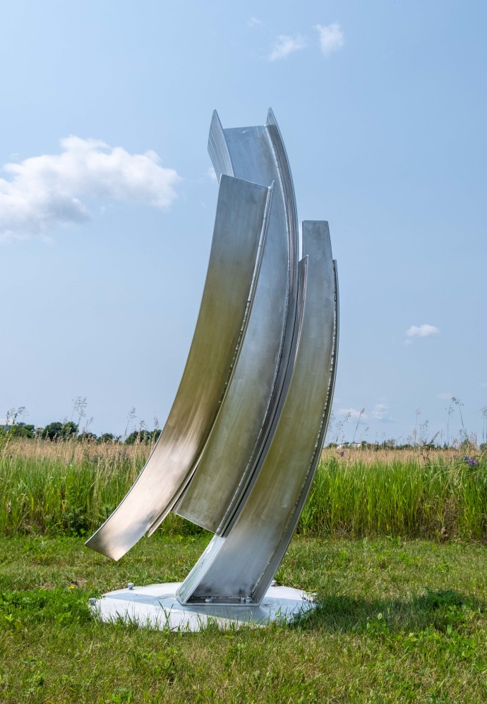 The graceful arc of a dancer in motion is emulated in the fluid form of this elegant sculpture by Claude Millette.