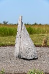 Concentric rings are carved on one side of this triangular chunk of limestone. Image 7