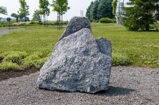 Concentric rings are carved on one side of this triangular chunk of limestone. Image 4