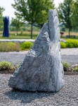 Concentric rings are carved on one side of this triangular chunk of limestone. Image 3