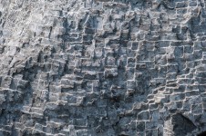 Concentric rings are carved on one side of this triangular chunk of limestone. Image 5