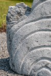 Concentric rings are carved on one side of this triangular chunk of limestone. Image 9