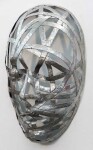 This contemporary wall sculpture is a series of three masks forged from metal. Image 4