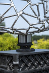 A human face emerges from the intricately designed stainless steel mesh of this intriguing sculpture. Image 6