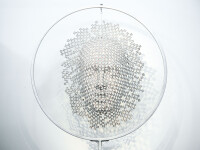 This contemporary metal sculpture of a mask is kinetic and was created by a Canadian artist. Image 2