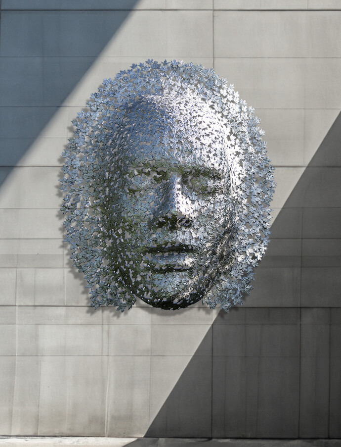 This contemporary wall sculpture of a mask is made out of metal.