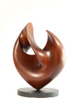 The graceful curves of this contemporary solid mahogany sculpture by David Chamberlain appear to emulate the image of a heart. Image 2