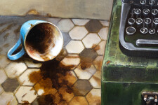 An old-fashioned typewriter sits on its worn green case against ripped and stained wallpaper; a blue mug lays beside it—the coffee spilled a… Image 4