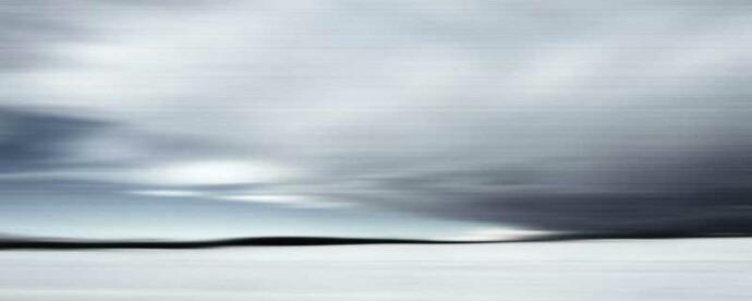 A storm in streaky black and grey billows up and across a wintry landscape, consuming the black horizon line in this C-print by Etienne Labb…