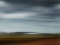 This captivating photo of the countryside—red roofed barn and cloudy sky was taken from a moving car by photographer Etienne Labbé. Image 2