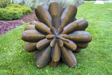 This contemporary outdoor sculpture was forged from steel; its form is inspired by nature. Image 4