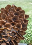 Hand forged from weathering steel Floyd Elzinga’s impressive outdoor sculpture of a pine cone is designed to house logs for a fire. Image 4