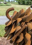 Hand forged from weathering steel Floyd Elzinga’s impressive outdoor sculpture of a pine cone is designed to house logs for a fire. Image 6