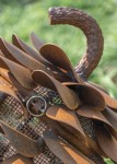 Hand forged from weathering steel Floyd Elzinga’s impressive outdoor sculpture of a pine cone is designed to house logs for a fire. Image 5