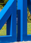 Two striking steel triangles painted in royal blue—in different sizes; their centers cut-out triangles stand beside one another in this new … Image 5