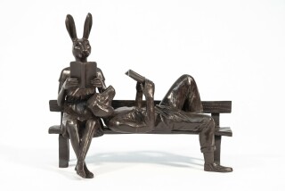 Captured reading books, this contemporary bronze figurative sculpture is by Gillie and Marc.