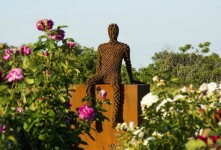 A seated figure reclines atop a steel cube in this intriguing work by Mississippi sculptor Jason Kimes. Image 2