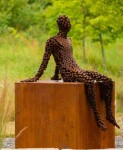 A seated figure reclines atop a steel cube in this intriguing work by Mississippi sculptor Jason Kimes. Image 4