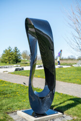 This large outdoor abstract sculpture by Jeremy Guy is hand-forged from stainless steel and finished in a glossy black.