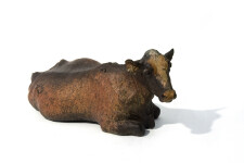 Charlot is a table-top sculpture of a regal adult female cow sitting, her beautiful face turned towards the viewer, legs tucked under her ma… Image 2