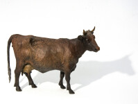 Meet Soprano. Cast in bronze, she is standing, quietly, her head slightly turned—her patina a rich brown and black. Image 5