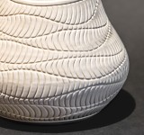 This delicately detailed vase in a creamy white is by Loren Kaplan. Image 3