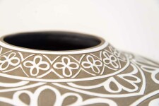 Exquisitely hand engraved white floral patterns adorn this taupe-coloured porcelain vessel by Loren Kaplan. Image 6