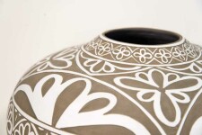 Exquisitely hand engraved white floral patterns adorn this taupe-coloured porcelain vessel by Loren Kaplan. Image 3