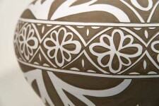 Exquisitely hand engraved white floral patterns adorn this taupe-coloured porcelain vessel by Loren Kaplan. Image 4