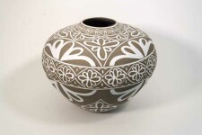 Exquisitely hand engraved white floral patterns adorn this taupe-coloured porcelain vessel by Loren Kaplan. Image 2