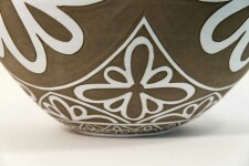 Exquisitely hand engraved white floral patterns adorn this taupe-coloured porcelain vessel by Loren Kaplan. Image 5