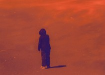 Helicopters hover over a lone figure stands on a scorched ground in this dramatic photo based image by Mark Bartkiw. Image 3