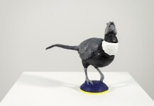 Cast in resin, a figurine of a pheasant posed on an indigo base points to a theme of human and animal interaction. Image 3